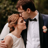 groom wearing a black and gold cork bow tie