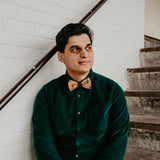 man wearing cork bow tie with black birds
