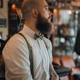 bearded guy with army green suspenders and bow tie