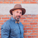 man with hat and cork bow tie