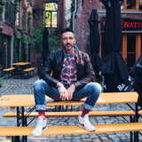 man with leather jacket and jeans bow tie