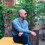 man wearing jeans shirt and cork bow tie