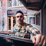 man wearing checkered shirt and yellow cork bow tie