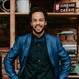 man in blue blazer and blue cork bow tie