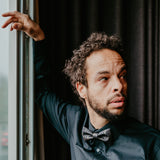 man wearing black shirt and bow tie in black and gold