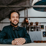 man in black shirt and 20s inspired bow tie