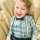 kid wearing green braces and bow tie