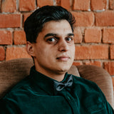 man in green suit and black bow tie made from cork fabric