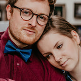 man wearing burgundy shirt and blue bow tie