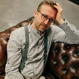 man wearing green suspenders  made from recycled denim