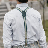 boy wearing green recycled jeans braces