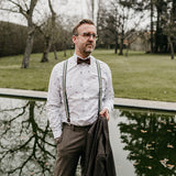 man wearing green suspenders and brown bow tie