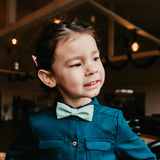 girl wearing mint bow tie