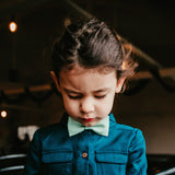 girl wearing mint green bow tie