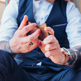 man holding wooden card holder