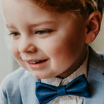 boy with blue bow tie