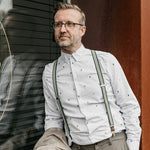 man wearing green suspenders with brown cork fabric