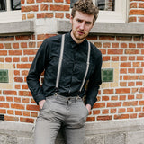 man wearing black shirt and suspenders made from recycled jeans