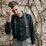 man wearing black shirt and suspenders made from recycled jeans