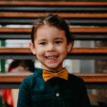 smiling girl wearing mustard cork bow tie 