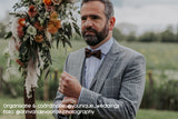 groom wearing dark brown cork bow tie