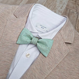 beige blazer with mint bow tie